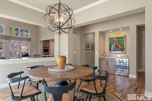 20605 Parc Foret Dr, Reno, NV 89511 - dining area featuring wine cooler, dark wood finished floors, a chandelier, baseboards, and ornamental molding