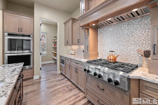 20605 Parc Foret Dr, Reno, NV 89511 - kitchen featuring stainless steel appliances, baseboards, light wood-style flooring, and decorative backsplash