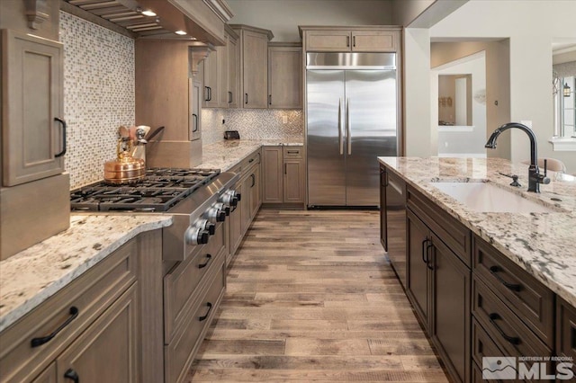 20605 Parc Foret Dr, Reno, NV 89511 - kitchen featuring stainless steel appliances, a sink, wall chimney range hood, and light wood-type flooring