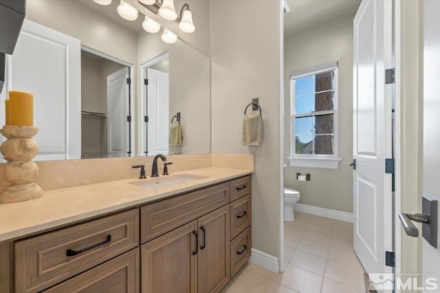 20605 Parc Foret Dr, Reno, NV 89511 - bathroom featuring toilet, vanity, tile patterned flooring, and baseboards