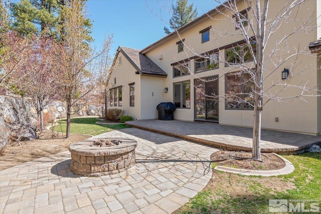 20605 Parc Foret Dr, Reno, NV 89511 - back of property featuring stucco siding, an outdoor fire pit, a patio, and a balcony