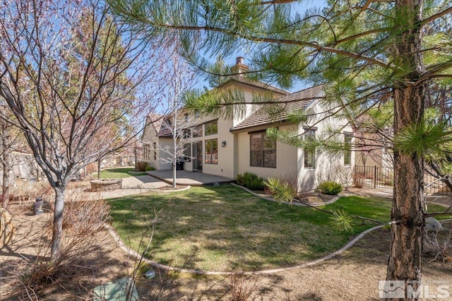 20605 Parc Foret Dr, Reno, NV 89511 - rear view of property featuring a patio area, stucco siding, a chimney, and a tile roof