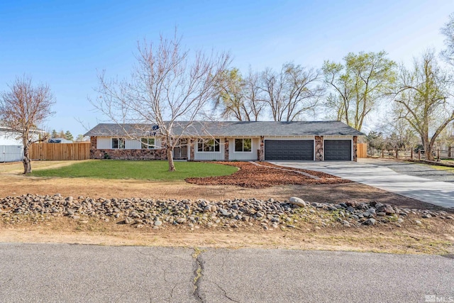 1309 Raeline Ln, Minden, NV 89423 - ranch-style home with concrete driveway, a garage, and stone siding