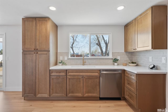 1309 Raeline Ln, Minden, NV 89423 - kitchen featuring stainless steel dishwasher, a sink, tasteful backsplash, light wood finished floors, and light countertops