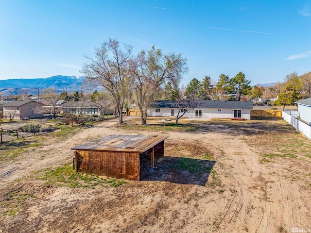 1309 Raeline Ln, Minden, NV 89423 - view of yard with a mountain view, fence, and an outbuilding