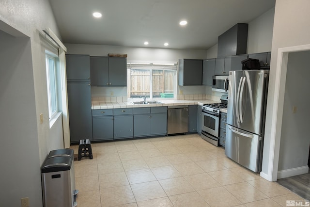 4806 Lincoln Ct, Carson City, NV 89706 - kitchen featuring appliances with stainless steel finishes, tile counters, gray cabinets, a sink, and recessed lighting