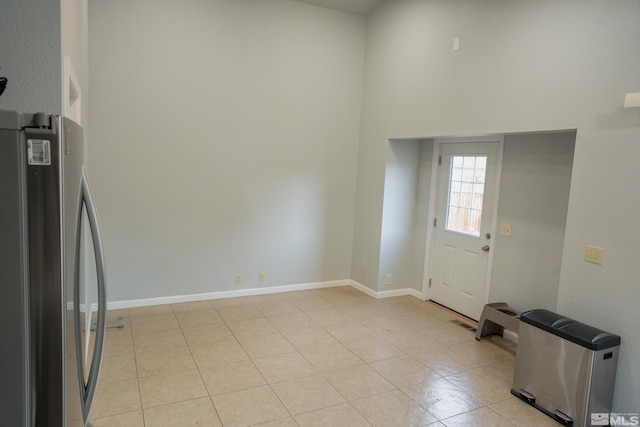 4806 Lincoln Ct, Carson City, NV 89706 - entrance foyer with a high ceiling, light tile patterned floors, and baseboards