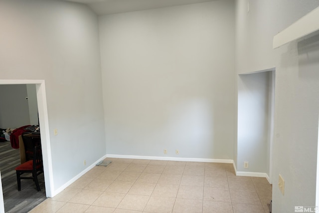 4806 Lincoln Ct, Carson City, NV 89706 - unfurnished room with baseboards, light tile patterned floors, and a towering ceiling