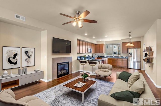 2490 Eastshore Pl, Reno, NV 89509 - living area with wood finished floors, ceiling fan, a glass covered fireplace, baseboards, and recessed lighting