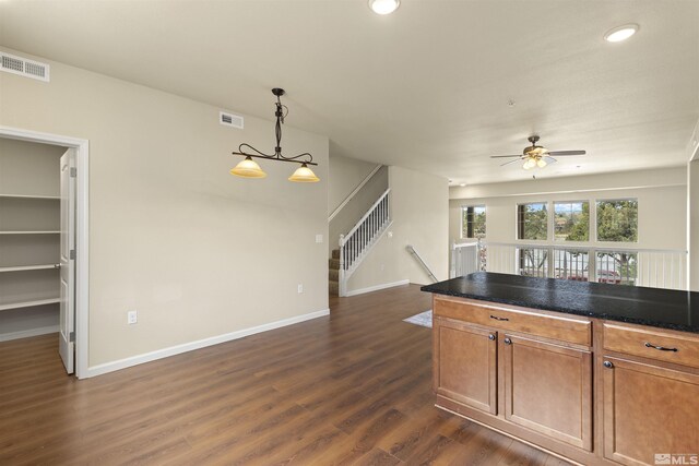 2490 Eastshore Pl, Reno, NV 89509 - kitchen with dark wood-style flooring, ceiling fan, brown cabinets, baseboards, and recessed lighting
