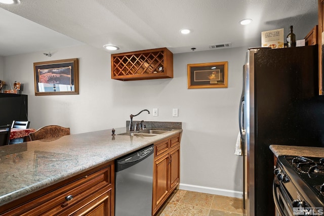 759 Boulder Ct Unit M, Stateline, NV 89449 - kitchen with stainless steel appliances, a sink, baseboards, brown cabinetry, and light stone counters
