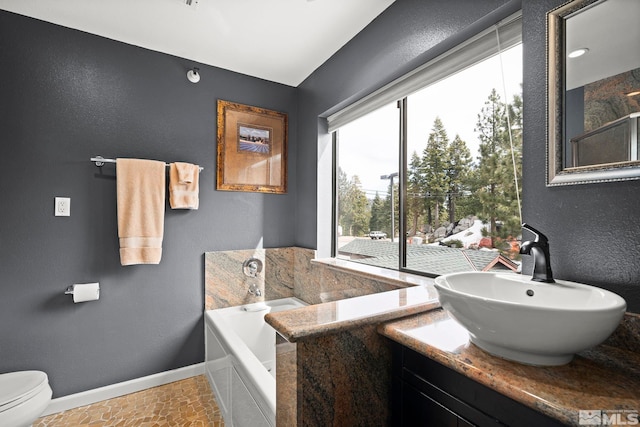 759 Boulder Ct Unit M, Stateline, NV 89449 - full bathroom with baseboards, a bath, vanity, toilet, and a textured wall