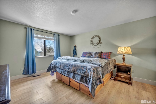 11000 Bighorn Dr, Reno, NV 89508 - bedroom with baseboards, a textured ceiling, and light wood-type flooring