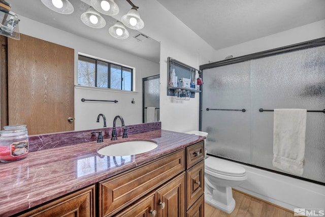 11000 Bighorn Dr, Reno, NV 89508 - full bathroom featuring vanity, toilet, wood finished floors, and shower / bath combination with glass door