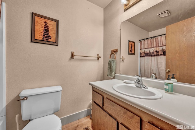 11000 Bighorn Dr, Reno, NV 89508 - bathroom with vanity, toilet, wood finished floors, baseboards, and curtained shower
