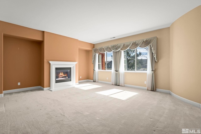 15355 Redmond Loop, Reno, NV 89511 - unfurnished living room with a glass covered fireplace, carpet, and baseboards