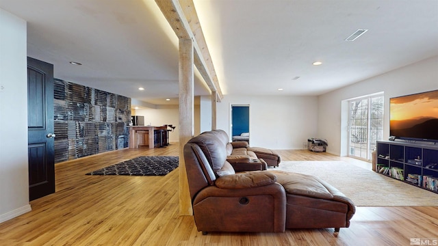 living room with wood finished floors, beamed ceiling, recessed lighting, and baseboards