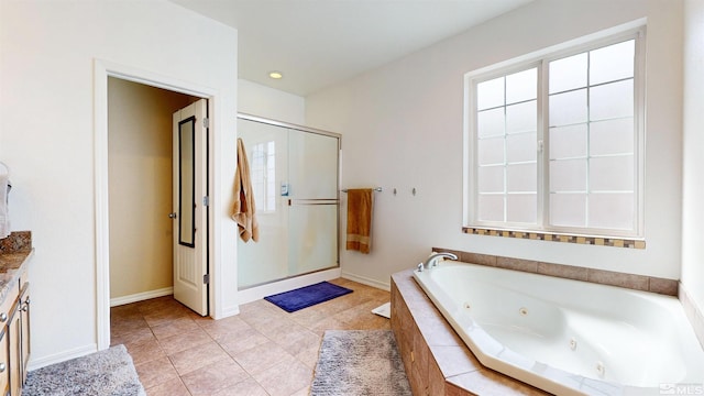 bathroom with a shower stall, a tub with jets, tile patterned floors, and baseboards