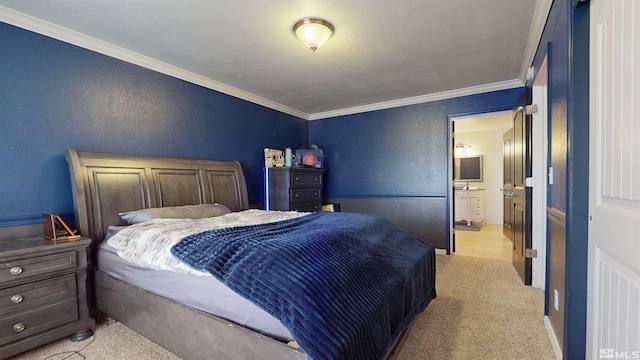 bedroom featuring ornamental molding, light colored carpet, and connected bathroom
