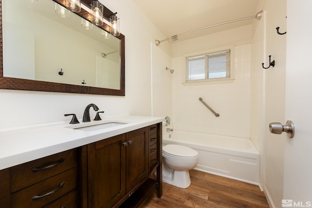full bathroom featuring wood finished floors, toilet, vanity, and  shower combination