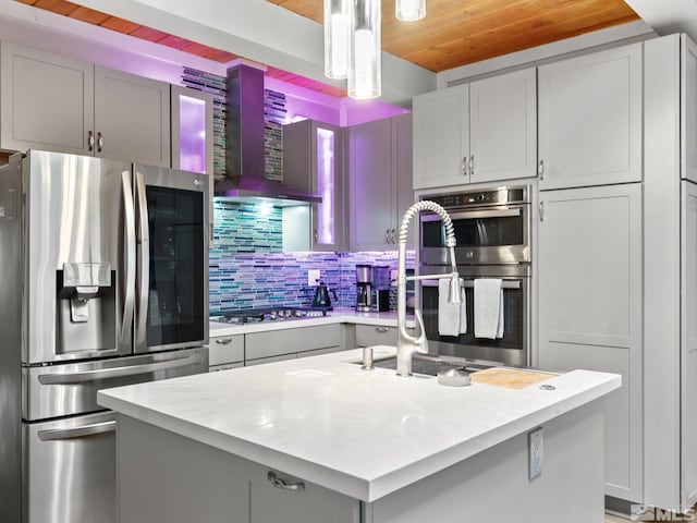 989 Tahoe Blvd Unit 91, Incline Village, NV 89451 - kitchen featuring stainless steel appliances, wooden ceiling, wall chimney range hood, light countertops, and tasteful backsplash
