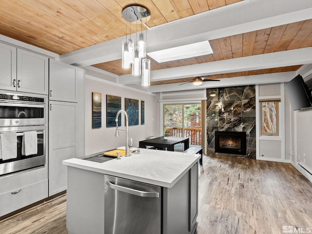 989 Tahoe Blvd Unit 91, Incline Village, NV 89451 - kitchen with wood ceiling, stainless steel appliances, light countertops, beamed ceiling, and light wood-type flooring