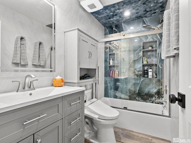 989 Tahoe Blvd Unit 91, Incline Village, NV 89451 - bathroom featuring combined bath / shower with glass door, vanity, tile walls, wood finished floors, and toilet