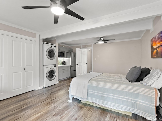 989 Tahoe Blvd Unit 91, Incline Village, NV 89451 - bedroom with stacked washer / dryer, freestanding refrigerator, wood finished floors, crown molding, and ceiling fan
