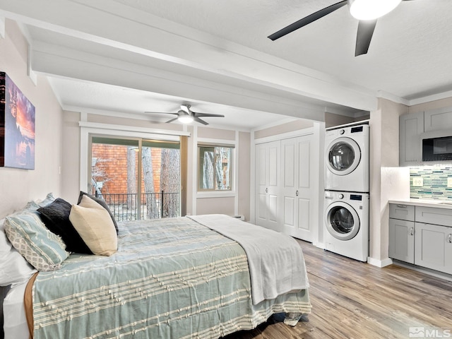 989 Tahoe Blvd Unit 91, Incline Village, NV 89451 - bedroom featuring stacked washer and clothes dryer, access to outside, light wood finished floors, and a ceiling fan