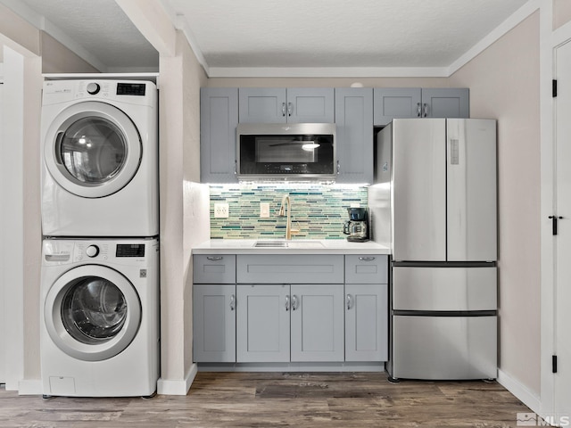 989 Tahoe Blvd Unit 91, Incline Village, NV 89451 - laundry room featuring stacked washer / drying machine, dark wood finished floors, baseboards, and ornamental molding
