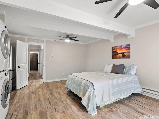 989 Tahoe Blvd Unit 91, Incline Village, NV 89451 - bedroom featuring stacked washer / drying machine, beamed ceiling, wood finished floors, baseboards, and baseboard heating