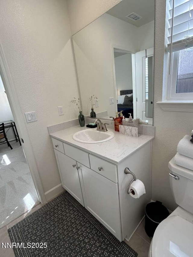 2234 Great Bluffs Ln, Sparks, NV 89436 - bathroom featuring toilet, ensuite bathroom, vanity, and a textured wall