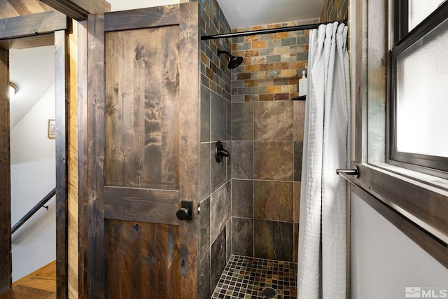 full bath featuring a tile shower