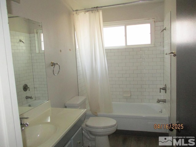 bathroom featuring shower / bath combo with shower curtain, vanity, toilet, and wood finished floors