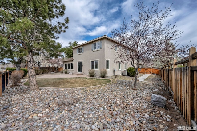 6647 Fabric Dr, Sparks, NV 89436 - rear view of property featuring stucco siding, a fenced backyard, a patio, and central AC