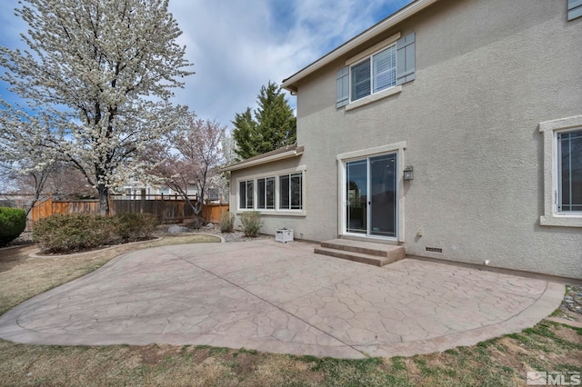 6647 Fabric Dr, Sparks, NV 89436 - back of house featuring stucco siding, a patio area, fence, and entry steps