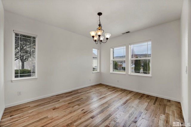 6647 Fabric Dr, Sparks, NV 89436 - unfurnished room featuring a chandelier, wood finished floors, and baseboards