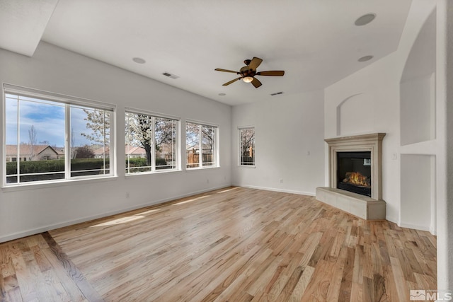 6647 Fabric Dr, Sparks, NV 89436 - unfurnished living room featuring light wood finished floors, a ceiling fan, a fireplace, and baseboards