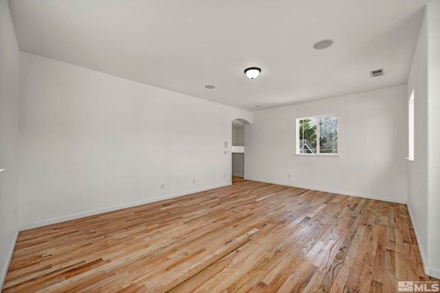 6647 Fabric Dr, Sparks, NV 89436 - spare room with arched walkways, light wood-type flooring, and baseboards