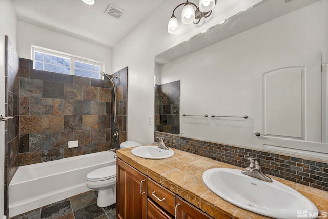 6647 Fabric Dr, Sparks, NV 89436 - bathroom with tasteful backsplash, tub / shower combination, toilet, double vanity, and stone finish floors