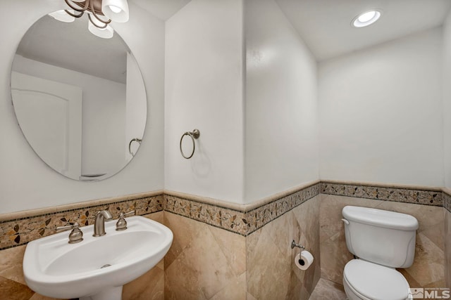 6647 Fabric Dr, Sparks, NV 89436 - bathroom with tile walls, wainscoting, a sink, and toilet
