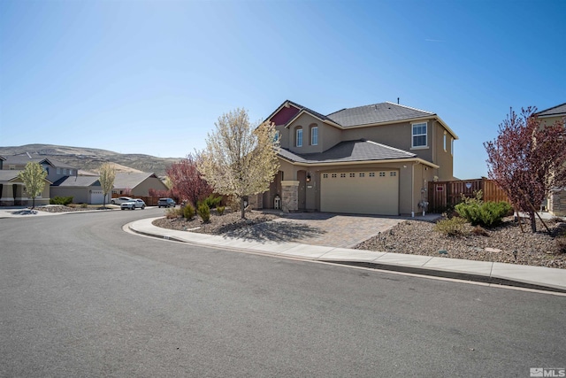 2575 Piero Ct, Sparks, NV 89434 - traditional-style house featuring driveway, a mountain view, a tiled roof, fence, and stucco siding