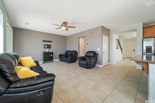 2575 Piero Ct, Sparks, NV 89434 - living area with a ceiling fan, light tile patterned floors, stairs, and baseboards
