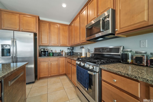 2575 Piero Ct, Sparks, NV 89434 - kitchen featuring stainless steel appliances, brown cabinetry, dark stone counters, and recessed lighting