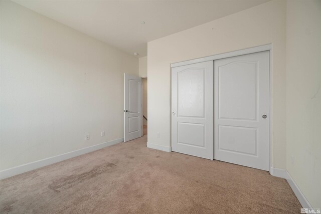 2575 Piero Ct, Sparks, NV 89434 - unfurnished bedroom with light carpet, baseboards, and a closet