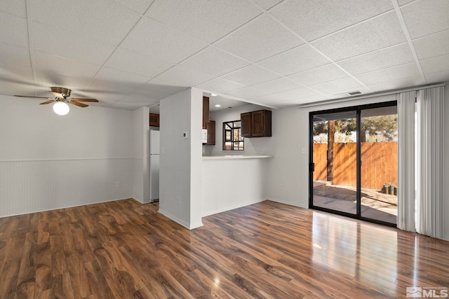 2193 Kietzke Ln Unit C, Reno, NV 89502 - unfurnished living room with a drop ceiling, dark wood-type flooring, a ceiling fan, and a wainscoted wall