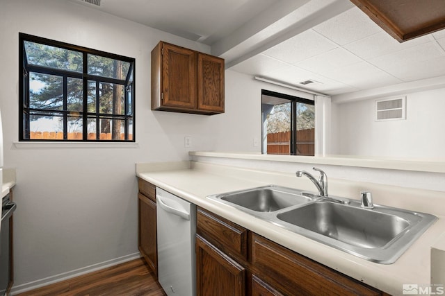 2193 Kietzke Ln Unit C, Reno, NV 89502 - kitchen with dishwasher, a sink, baseboards, light countertops, and dark wood-style floors