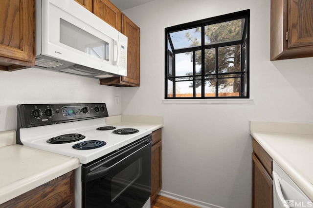 2193 Kietzke Ln Unit C, Reno, NV 89502 - kitchen featuring white appliances, brown cabinets, light countertops, and baseboards