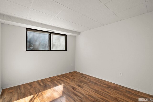 2193 Kietzke Ln Unit C, Reno, NV 89502 - empty room featuring dark wood-style flooring, baseboards, and a paneled ceiling