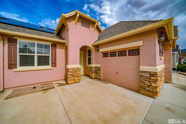 166 Oakridge Dr, Dayton, NV 89403 - view of front of home featuring stone siding, driveway, a garage, and stucco siding